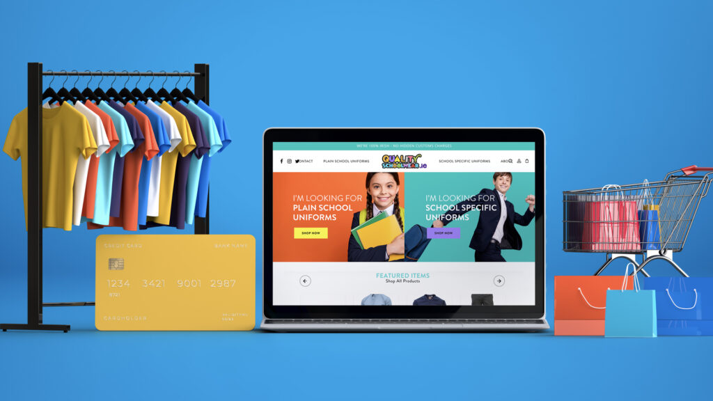 E-commerce website on laptop screen with shopping items, T-shirts, and credit card against blue background.