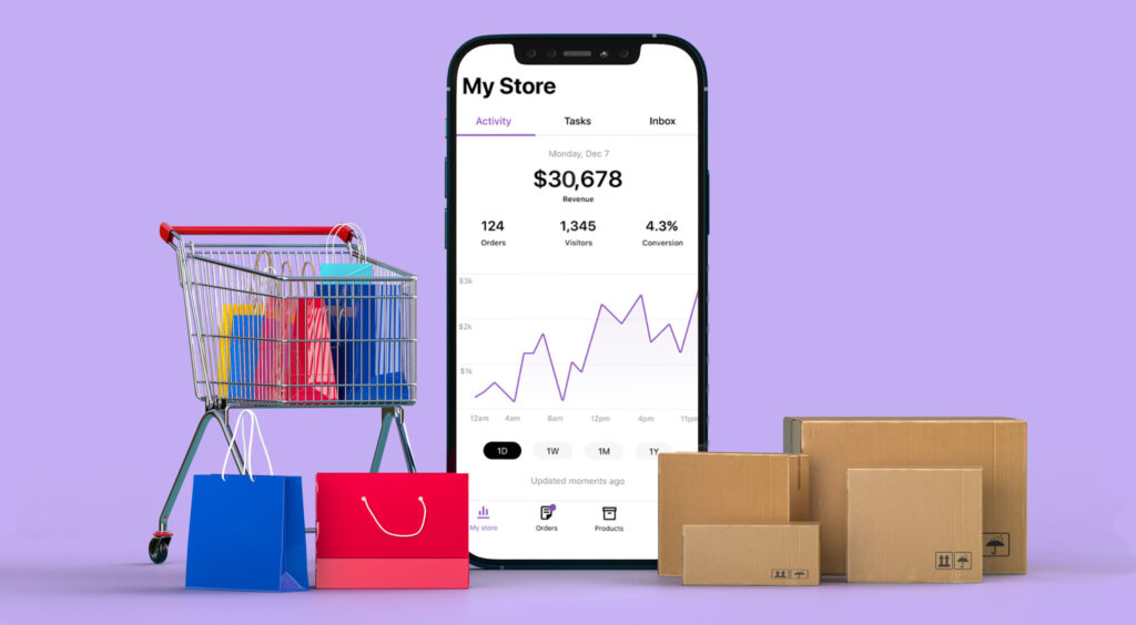 Shopping cart and phone app displaying sales data with boxes and bags, representing digital marketing in Dublin.